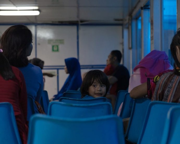 people sitting on blue gang chairs
